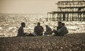 The old pier and the people on the beach, Brighton. Royalty Free Stock Photo