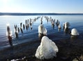 Old pier with wave ice glistening in sunshine Royalty Free Stock Photo