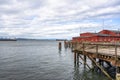 Old pier with wooden decking and an administrative building for the pilot boats and ships were anchored in Astoria at the mouth of Royalty Free Stock Photo