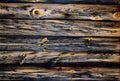 Old pine horizontal boards. The wood texture is brown-yellow with rings and cracks. Royalty Free Stock Photo