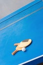 Old pingpong rackets and ball and net on blue pingpong table Royalty Free Stock Photo