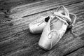 Old pink ballet shoes on a wooden floor Royalty Free Stock Photo