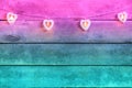 Old pink and blue neon wooden background with a garland of white burning hearts. The concept of a Declaration of love