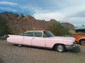 Old, pink Cadillac car in the desert Royalty Free Stock Photo