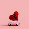 Old pink car with red heart on the roof on pink background Royalty Free Stock Photo