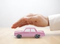 Old pink car toy covered by hand Royalty Free Stock Photo