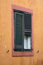 Old pink window on orange wall close up Royalty Free Stock Photo