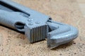 Old pipe wrench on a cork background. Plumber adjustable wrench Royalty Free Stock Photo