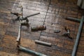 Old pipes and taps are laid out on wooden floor Royalty Free Stock Photo