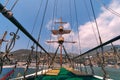 Old pirate ship on the water of Mediteranean sea. Tourist entertainment, coastal tour. Summer sunny day. Mountain shore of Alanya