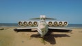 Old plane on beach. Action. Military plane landed on coast of sea many years ago. Abandoned military plane on seashore Royalty Free Stock Photo