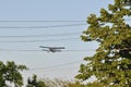 Old plane flying near electricity wire Royalty Free Stock Photo