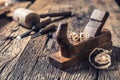 Old planer and other vintage carpenter tools in a carpentry workshop