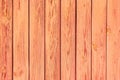 Old plank wood coral background. Peeling faded red or orange paint on old boards. Copying space Royalty Free Stock Photo