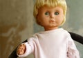 Old plastic doll with blonde hair. Royalty Free Stock Photo