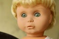 Old plastic doll with blonde hair. Royalty Free Stock Photo