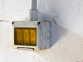 Old plastic switch against a white plaster wall Royalty Free Stock Photo