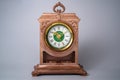 Old plastic table clock from the USSR with gold stopped hands. Brown vintage watch with round white green dial and Roman Royalty Free Stock Photo