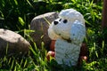 old plastic toy dog in summer garden Royalty Free Stock Photo