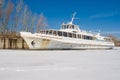 An old pleasure boat on a winter river. Royalty Free Stock Photo