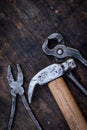 Old pliers, hammer and pincers on an old wooden workbench. Old work tools Royalty Free Stock Photo