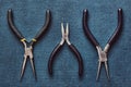 Old pliers and round pliers on blue background Royalty Free Stock Photo