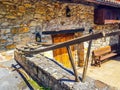 Old plow located at the entrance of a house in Spain as decoration. The plow was used in the field to plough the field pulled by