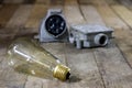 Old plug and socket high voltage. Old electrical accessories. Wooden table. Royalty Free Stock Photo