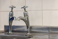 Old plumbing. Badly fitted sink taps with limescale. Selective f Royalty Free Stock Photo