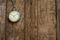 Old pocket watch and chain, vintage locket watch on chestnut rustic wooden background