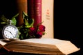 Old pocket watch in focus on old opened book Royalty Free Stock Photo