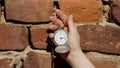 Old pocket watch in the hand of a girl caught on a retro background Royalty Free Stock Photo