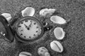 An old pocket watch lying in the sand. Royalty Free Stock Photo