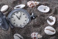 An old pocket watch lying in the sand. Royalty Free Stock Photo