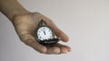 An old pocket watch on opening in a woman`s hand shows 5 minutes to 12 o`clock. Negative space. Copy space for advertising Royalty Free Stock Photo