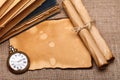 Old pocket watch with rolls and books Royalty Free Stock Photo