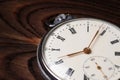 Old pocket watch on wooden background close up Royalty Free Stock Photo
