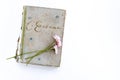 Old poetry book of Russian poet Sergei Yesenin on a white background. Bouquet of flowers from daisies. View from above. Royalty Free Stock Photo