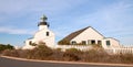 OLD POINT LOMA HISTORIC LIGHTHOUSE AT CABRILLO NATIONAL MONUMENT UNDER BLUE CIRRUS CLOUDS AT POINT LOMA SAN DIEGO CALIFORNIA USA Royalty Free Stock Photo
