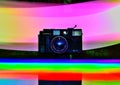 An old point and shoot film camera. Photograph painted in rainbow colours using light painting technique.