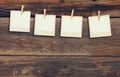 Old polaroid photo frames hanging on a rope with wooden background Royalty Free Stock Photo