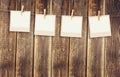 Old polaroid photo frames hanging on a rope with wooden background Royalty Free Stock Photo