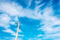 Old pole to hold disused electrical cables with blue sky and clouds, copy space Royalty Free Stock Photo