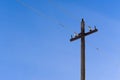 An old pole for wire on blue sky background Royalty Free Stock Photo
