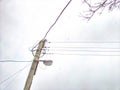 Old pole with wires against the sky. Electric transmission line. Eco-friendly energy