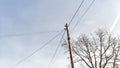 Old pole with wires against the sky. Electric transmission line. Eco-friendly energy