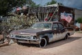 Old Police Sheriff car, fourth generation Chevrolet Biscayne with a red siren on the roof, abandoned