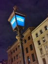 Old police street light lit up at night, London, England, UK