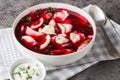 Old Polish beetroot borscht with traditional uszka dumplings stuffed with cabbage and mushrooms close-up in a bowl. Horizontal Royalty Free Stock Photo