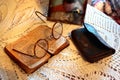 Old Polish Bible, retro spectacles and vintage mirror on a tablecloth. Old age, senility and poverty concept.